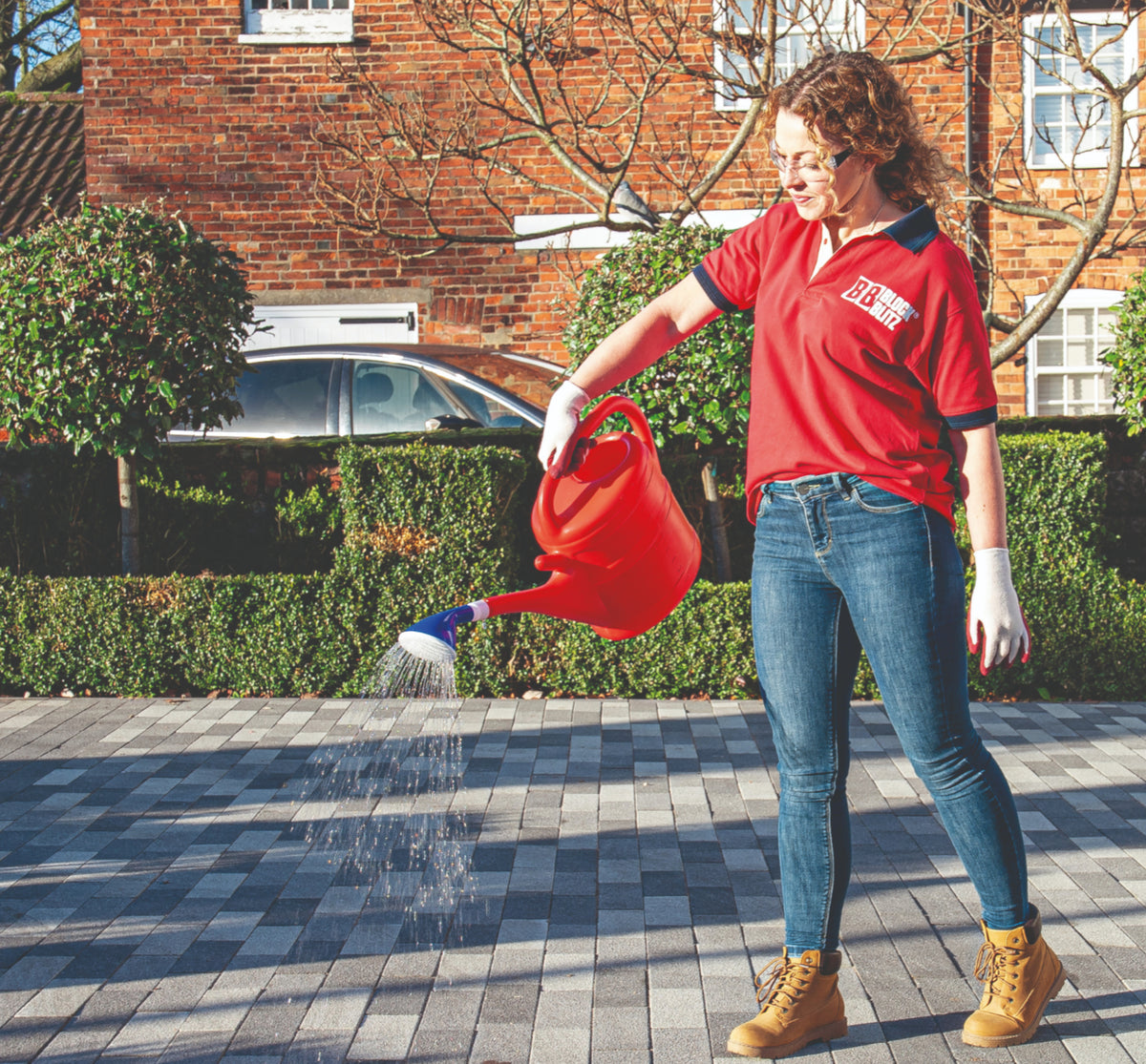 Block Blitz being applied to a block-paved driveway with a watering can