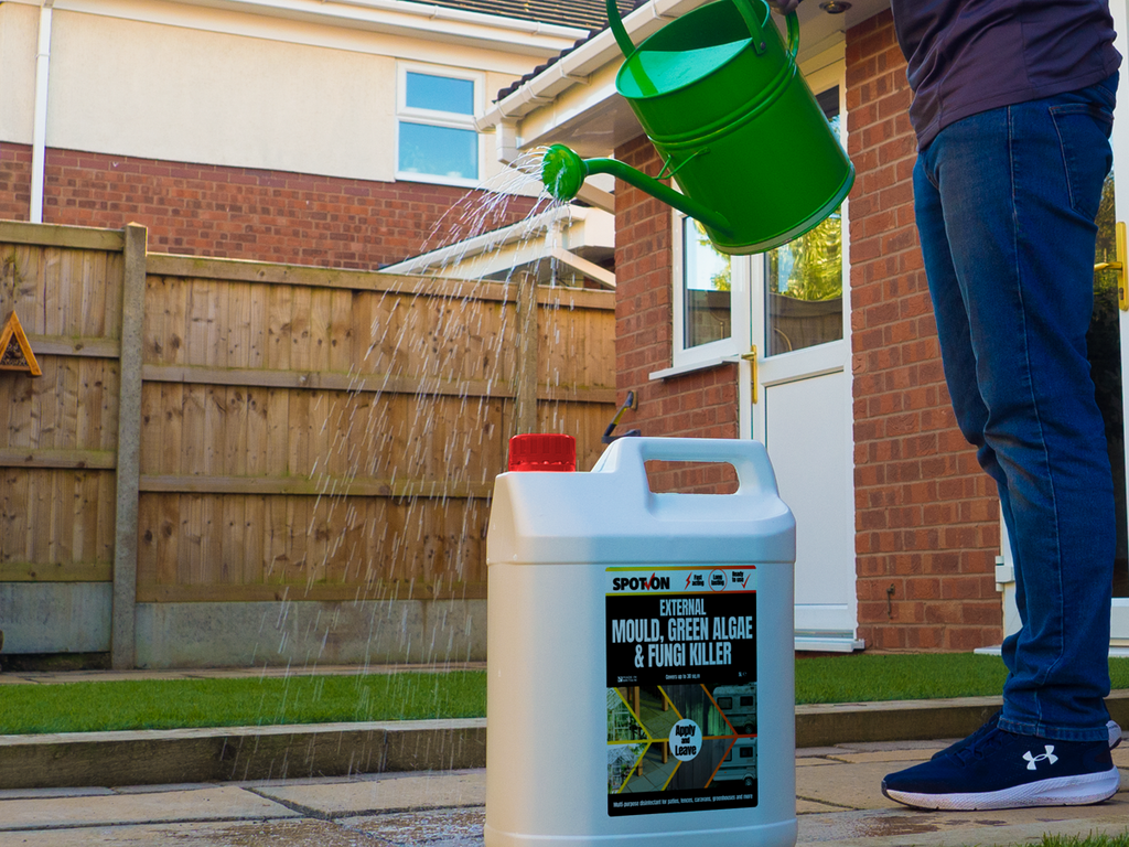 Applying SPOT-ON External Mould, Green Algae & Fungi Killer with a watering can